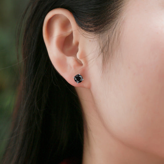 Close-up of black mosan diamond stud earrings worn on ear by Tree of Life Studio