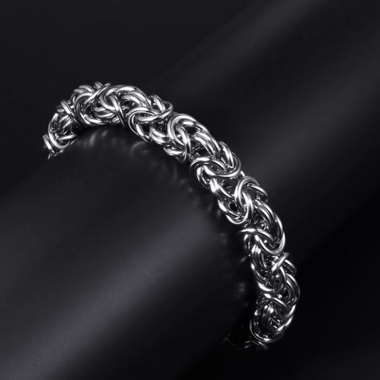 Braided stainless steel link bracelet by Tree of Life Studio with intricate interwoven links on black background