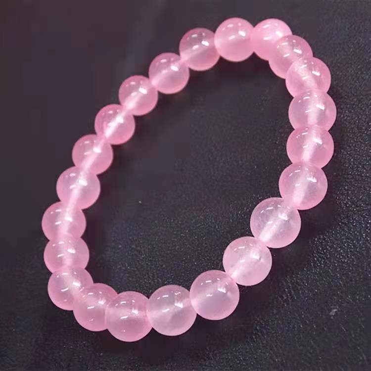 Tree of Life Studio genuine rose quartz beaded bracelet with polished round pink stones on black background