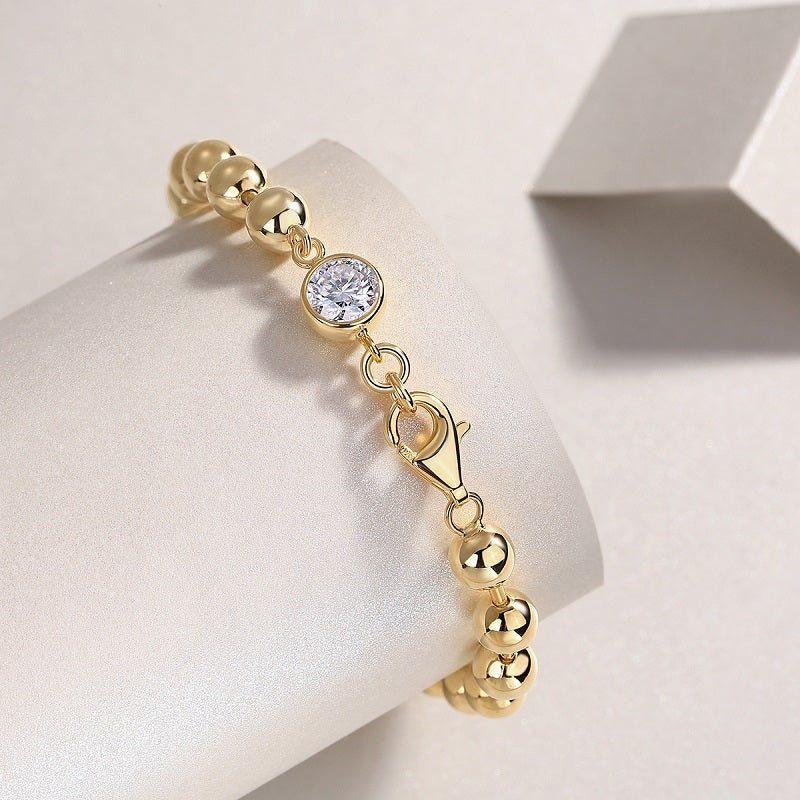 Gold plated moissanite jewelry for women bracelet with polished round beads and a sparkling center stone