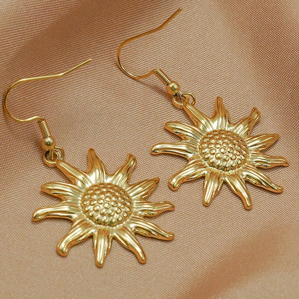 18K gold sun pendant necklace earring set hypoallergenic gold sun-shaped earrings on beige fabric