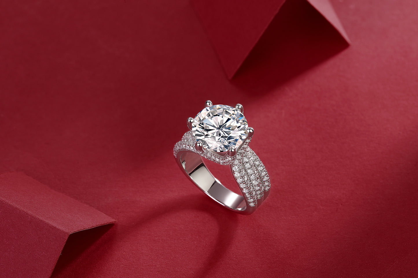 Large silver moissanite ring with multiple small sparkling stones and intricate band design