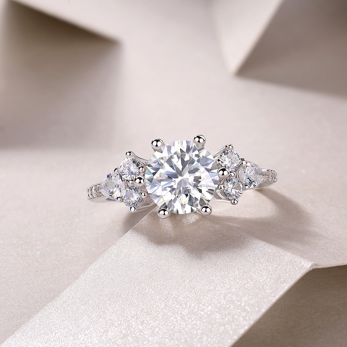 Luxury moissanite engagement ring with a large center stone and side diamonds from Tree of Life Studio