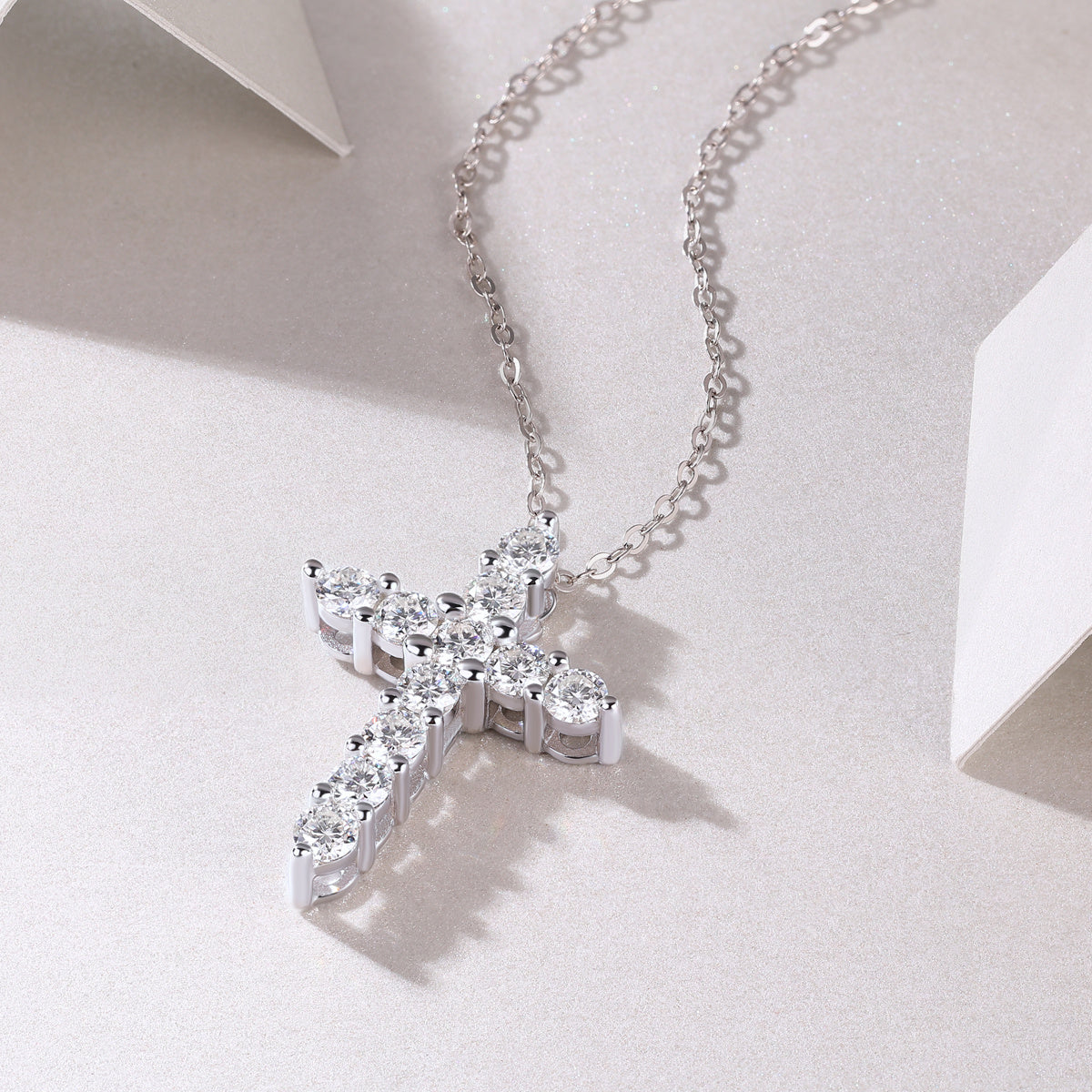 Elegant moissanite cross pendant necklace with sparkling stones on delicate silver chain from Tree of Life Studio