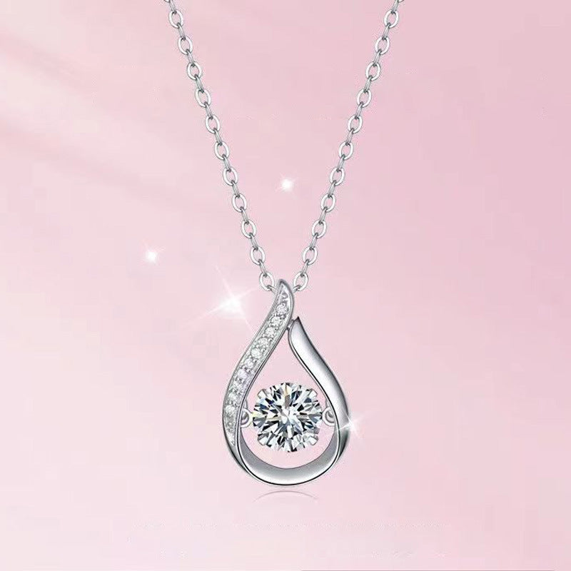 Moissanite water drop 925 silver necklace with sparkling round center stone and chain on pink background