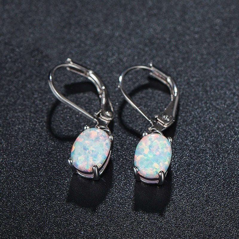 Tree of Life Studio opal drop earrings with oval opal stones set in silver metal hooks