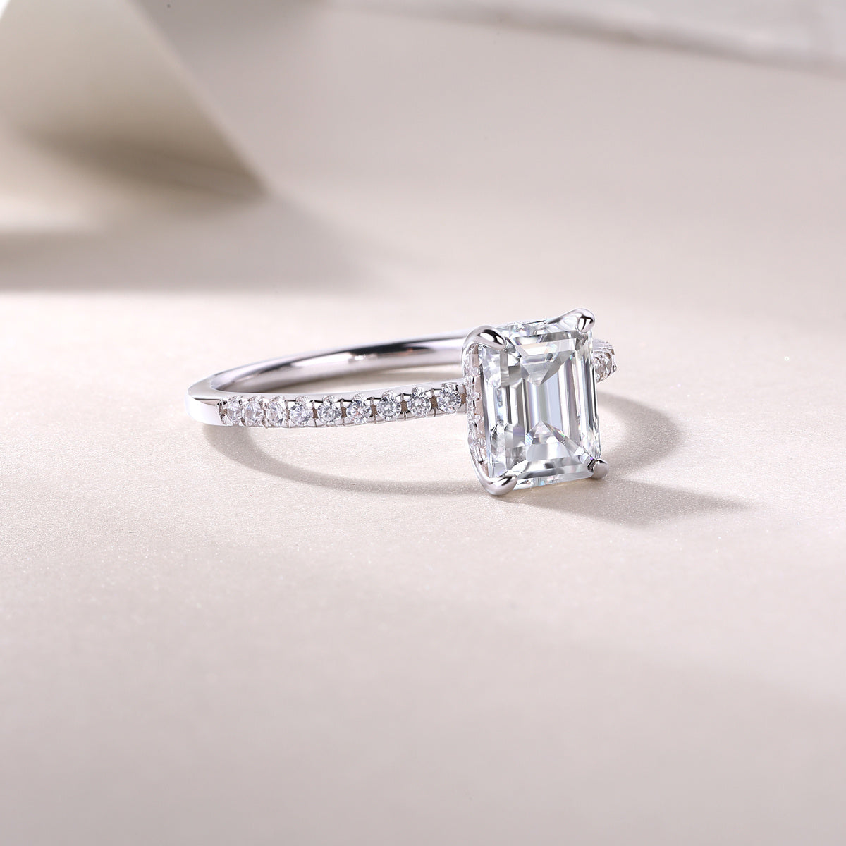 Tree of Life Studio princess cut moissanite diamond ring with pavé band on a soft beige background