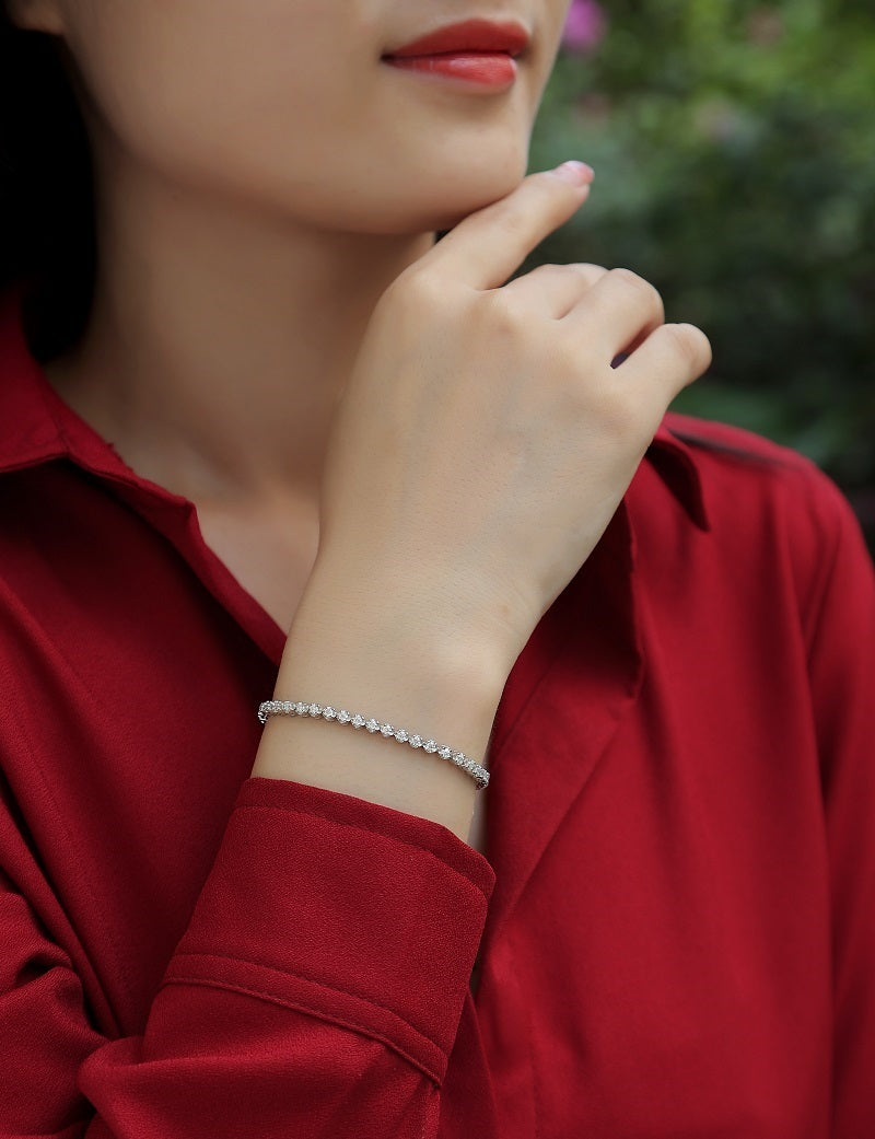 S925 silver moissanite diamond bracelet on wrist worn by woman in red top from Tree of Life Studio