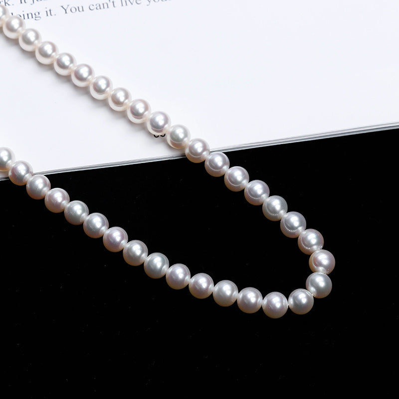 Tree of Life Studio spiritual pearl necklace for women with white round pearls on black and white background