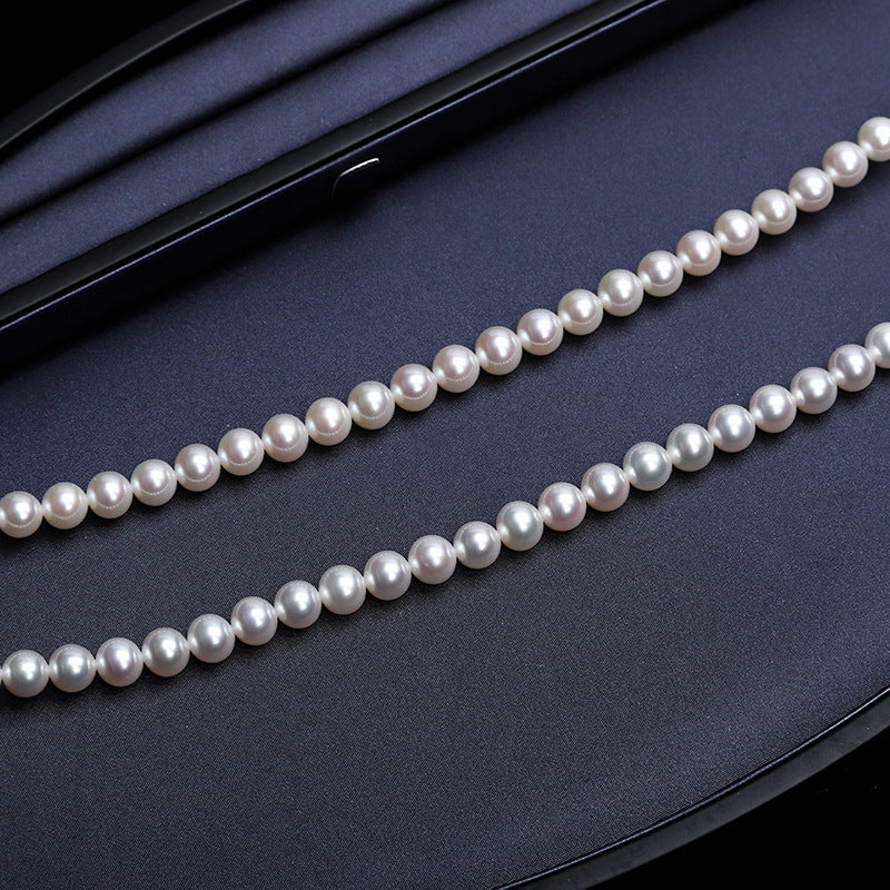 Tree of Life Studio spiritual pearl necklace for women with classic white and grey pearls on black background