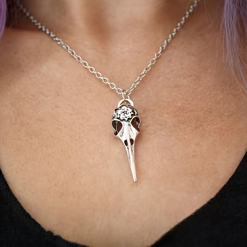 Spiritual Vulture skull necklace pendant hanging on a silver chain worn around the neck