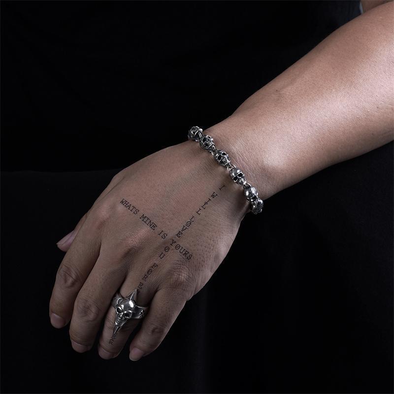 Tree of Life Studio spiritual skull charm bracelet worn on wrist with matching skull ring and tattoo