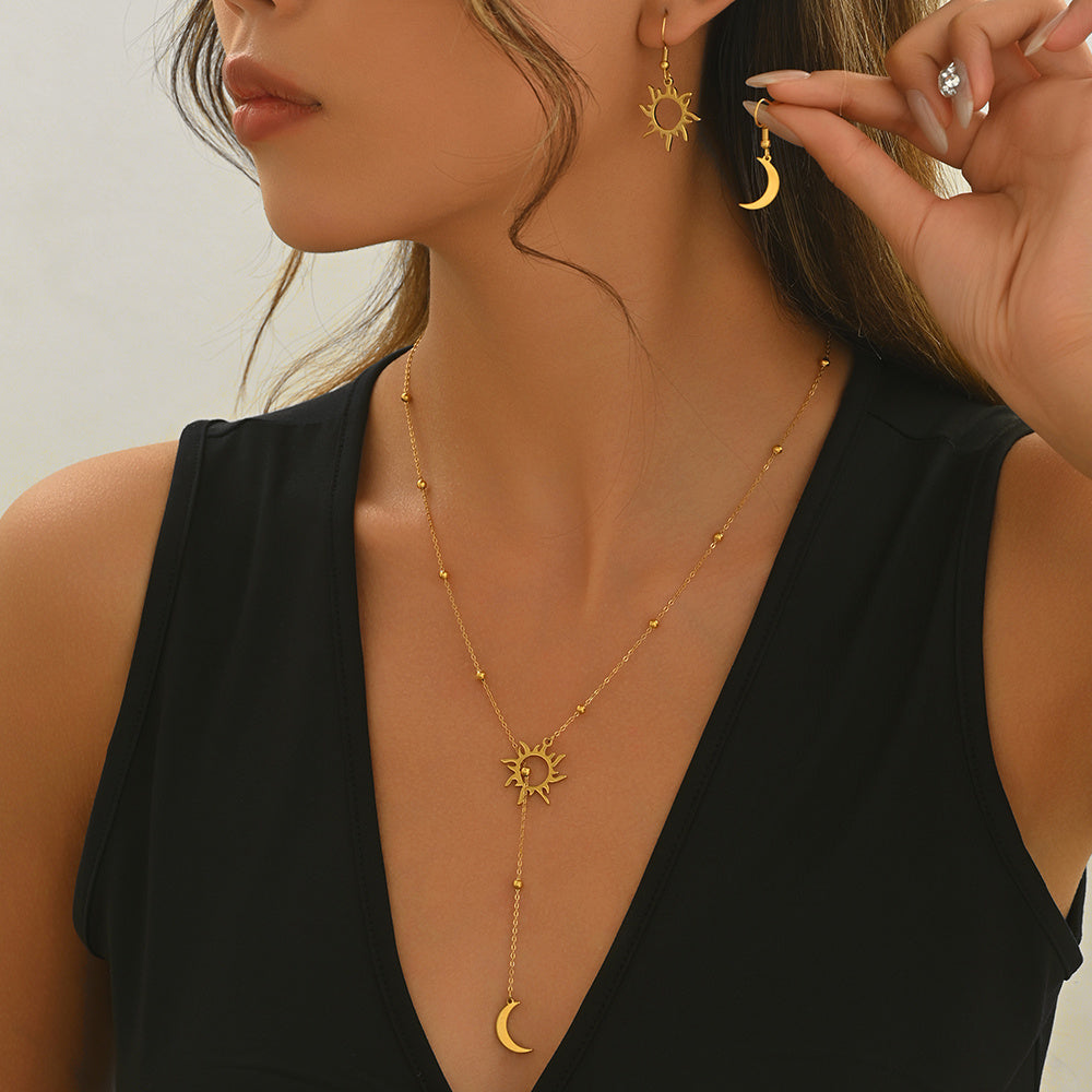 Tree of Life Studio gold sun and moon jewelry set with necklace and matching earrings on model