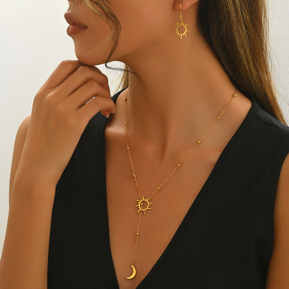 Tree of Life Studio gold sun and moon jewelry set necklace and matching earrings on woman