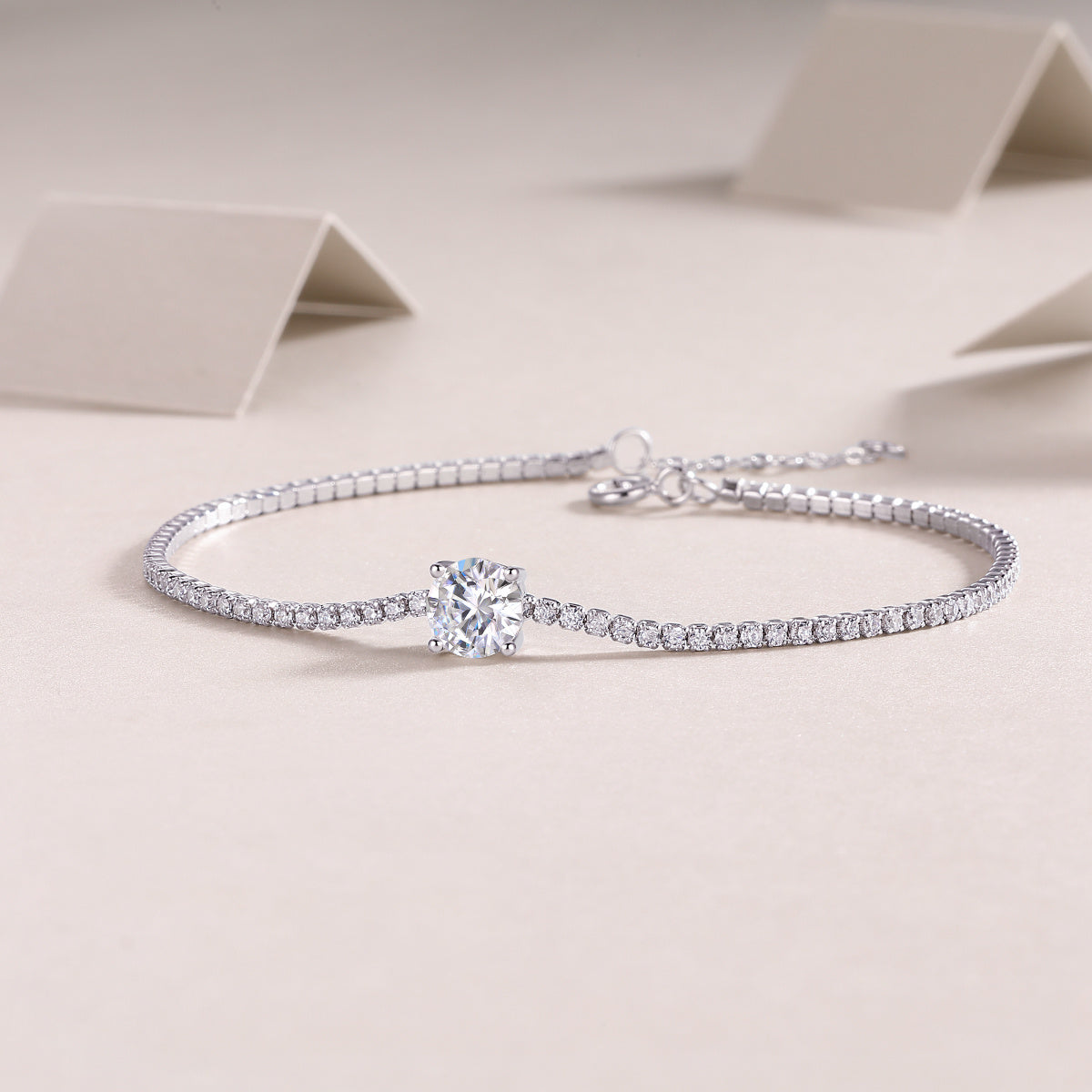 The Dawn high quality moissanite bracelet by Tree of Life Studio featuring a sparkling center stone with a delicate silver chain