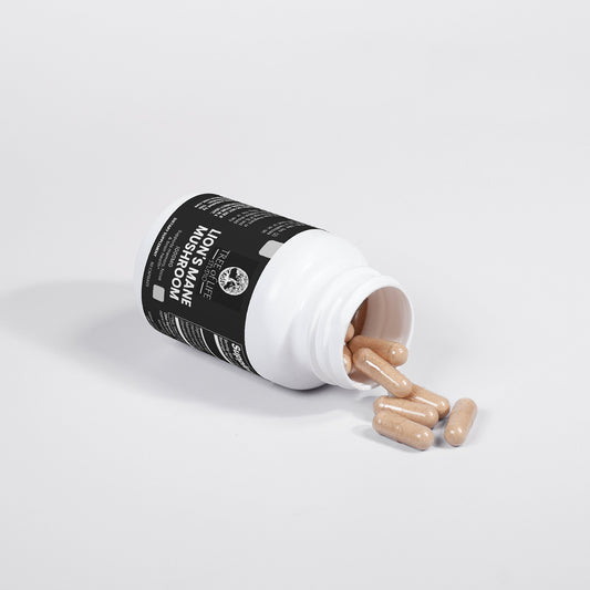 Tree of Life Studio Lion's Mane Mushroom supplement capsules spilling from white bottle on white background