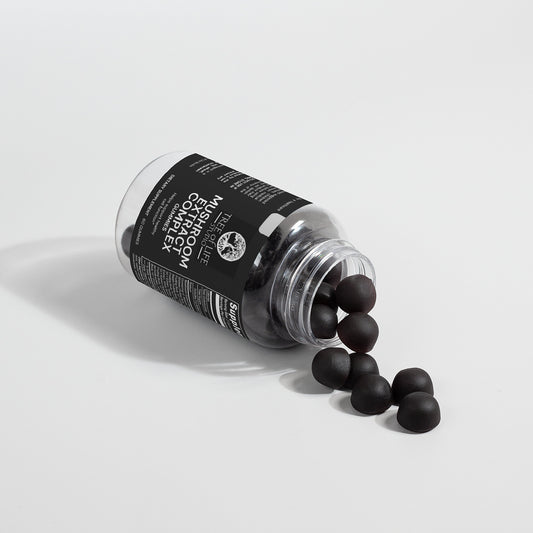 Tree of Life Studio mushroom extract complex gummies spilled from clear bottle with black label