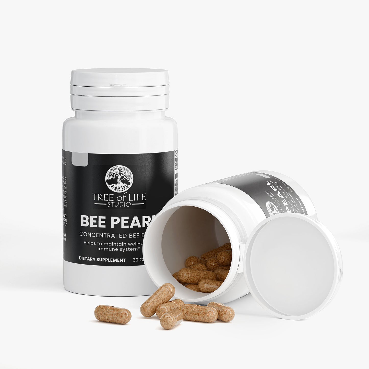 Tree of Life Studio premium bee pearl dietary supplement bottles with capsules spilled on white background