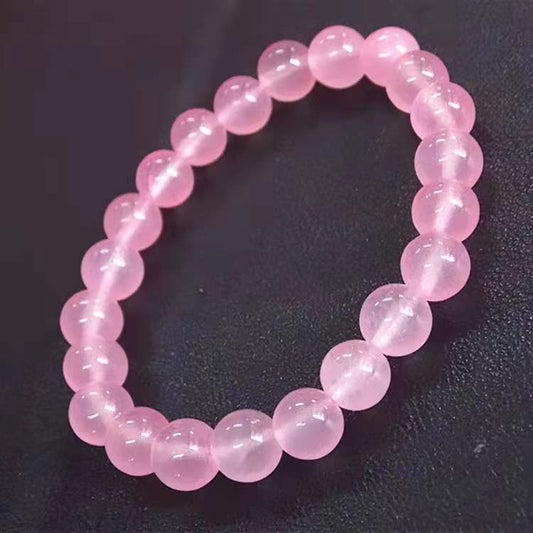 Tree of Life Studio genuine rose quartz beaded bracelet with polished round pink stones on black background