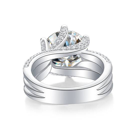 Large silver moissanite ring by Tree of Life Studio with intricate band and sparkling gemstone