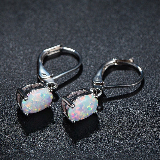 Tree of Life Studio opal drop earrings with iridescent oval stones set in silver clasps