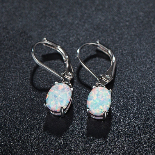 Tree of Life Studio opal drop earrings with oval opal stones set in silver metal hooks