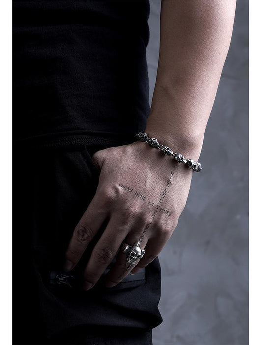 Tree of Life Studio spiritual skull charm bracelet worn on wrist with skull ring and dark clothing