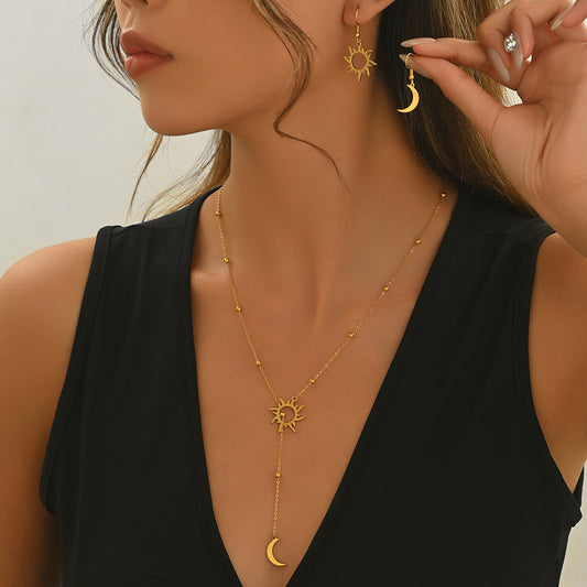 Tree of Life Studio gold sun and moon jewelry set with necklace and matching earrings on model