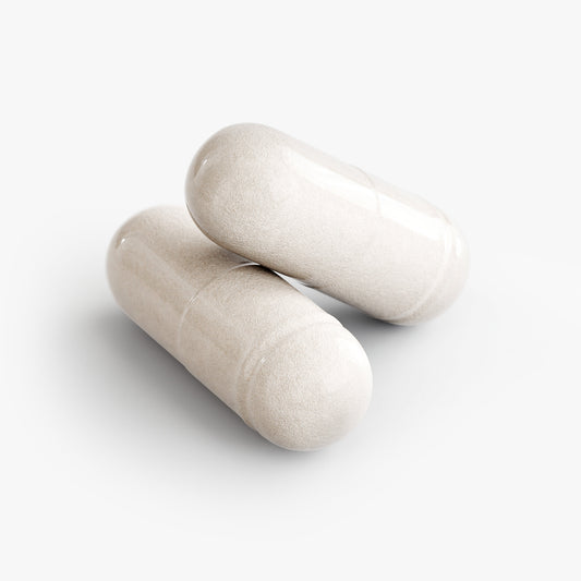 Close-up of two white capsules containing American made 5-HTP supplement by Tree of Life Studio